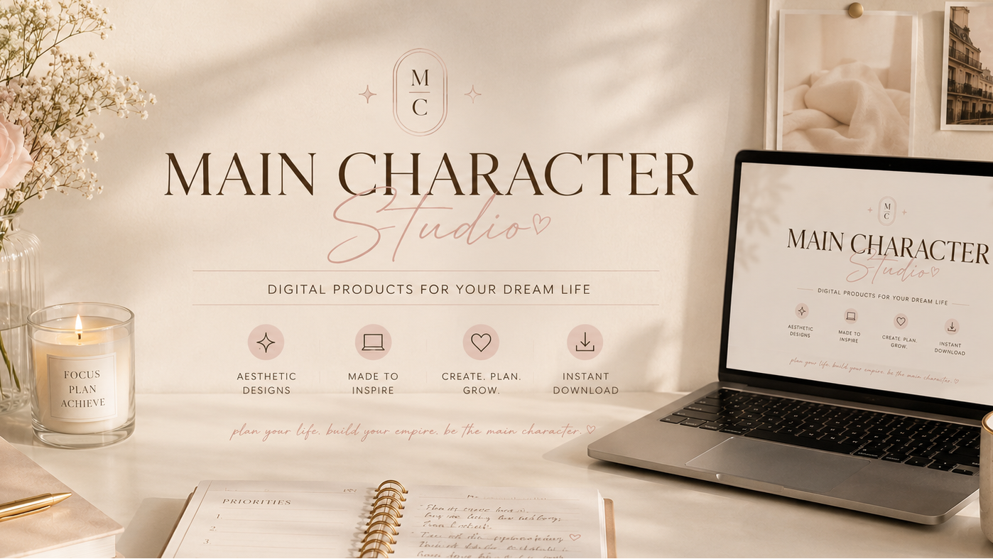 Laptop on a desk with 'Main Character Studio' branding, flowers, and a candle.